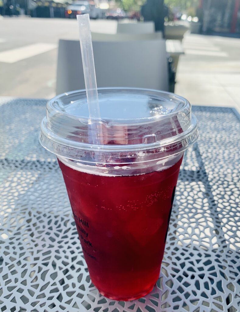 Cherry pomegranate syrup with san pellegrino sparkling water from Influx Little Italy