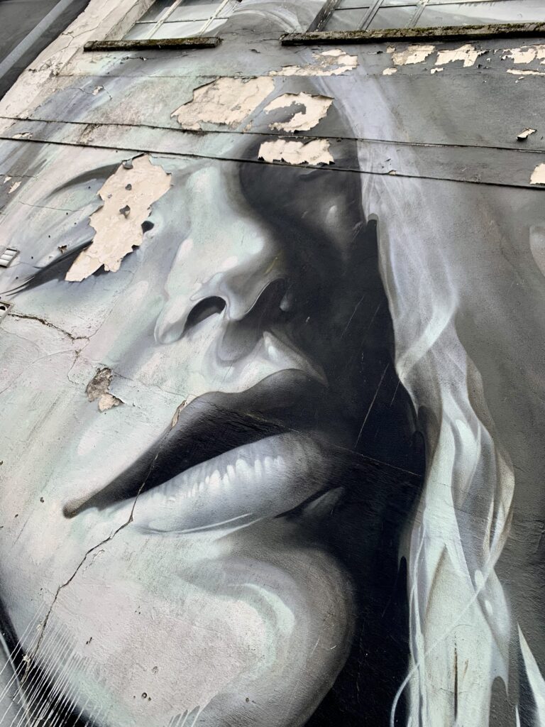 Rmer One mural: a black‑and‑white portrait of a woman