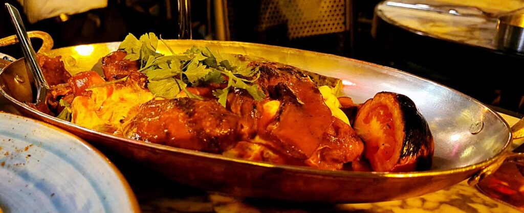 Kebab with yoghurt served over cubes of pita