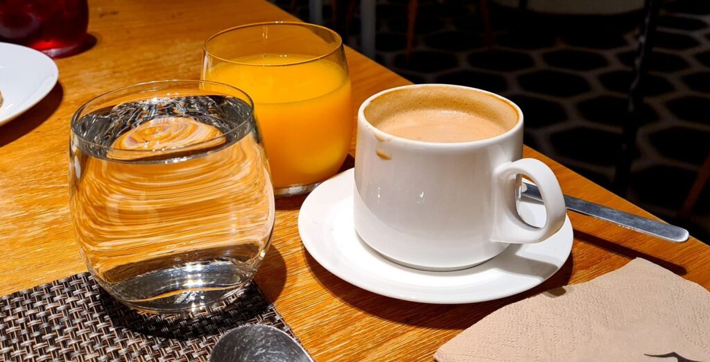 Coffee and juice at breakfast in Qantas First Lounge Los Angeles Airport