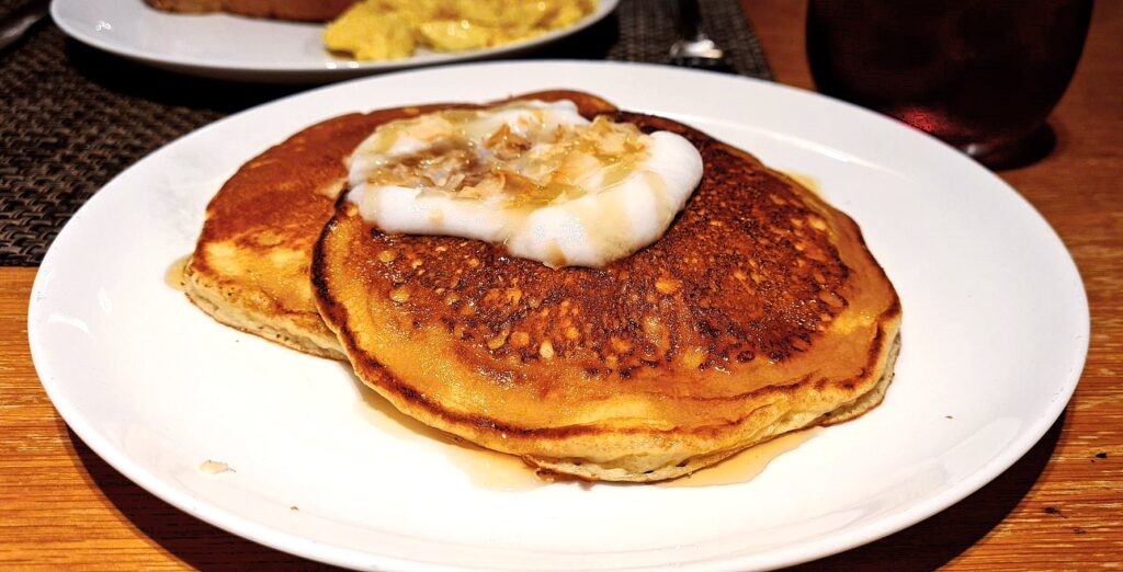 Pancakes with Maple syrup and yoghurt breakfast in Qantas First Lounge Los Angeles Airport