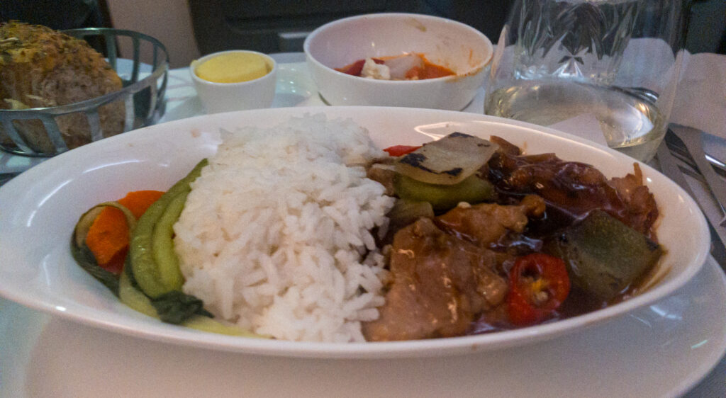 Chicken in black bean sauce, accompanied by steamed bok choi and jasmine rice.