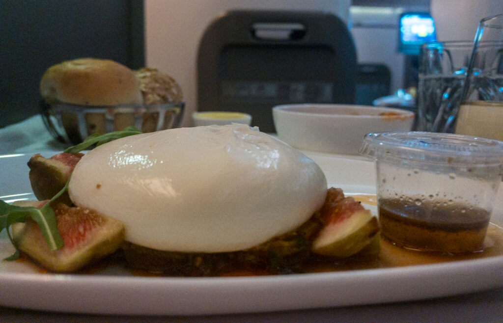 Italian Burrata paired with roasted pepper caponata, fig, and a drizzle of truffle honey