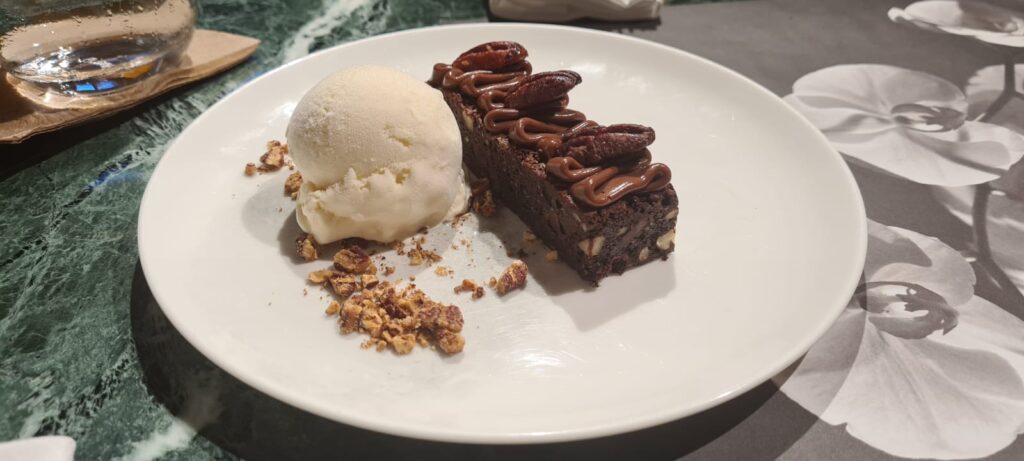 Warm chocolate and pecan brownie paired with olive oil ice cream